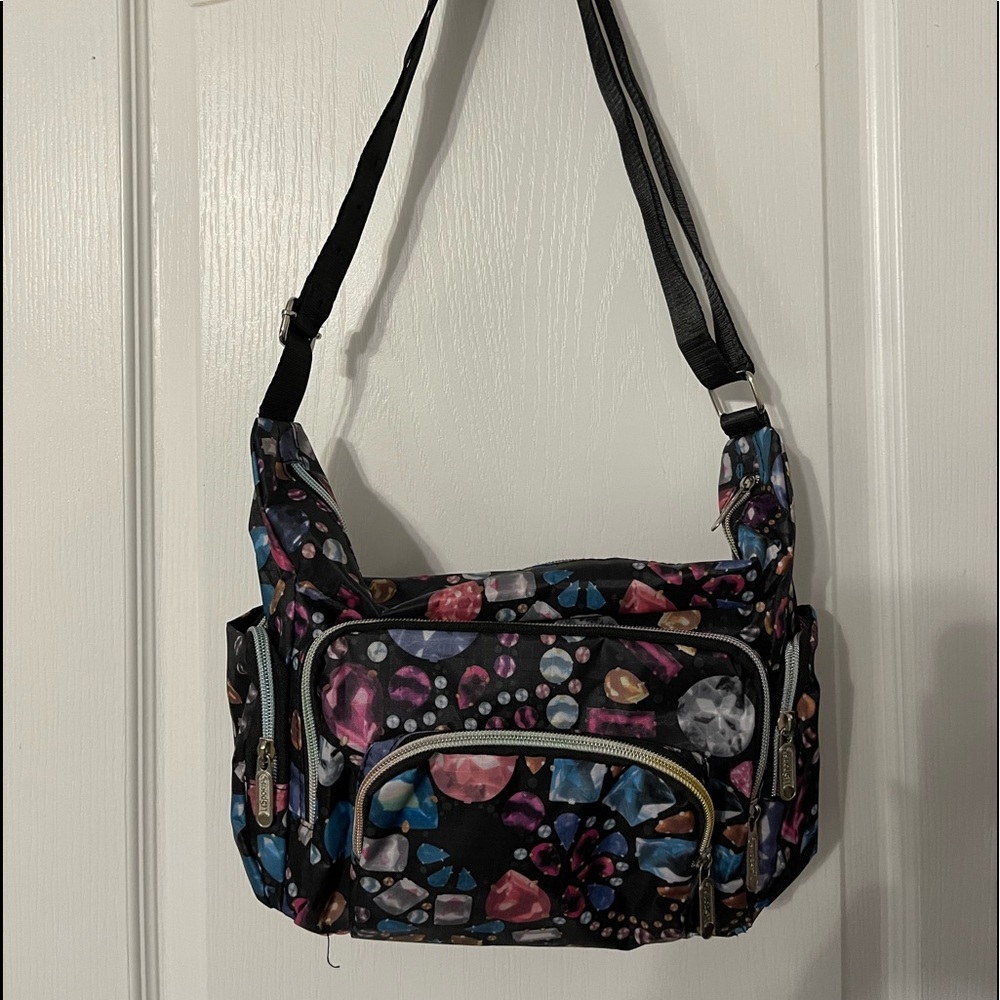 Floral handbag with adjustable strap and multiple pockets